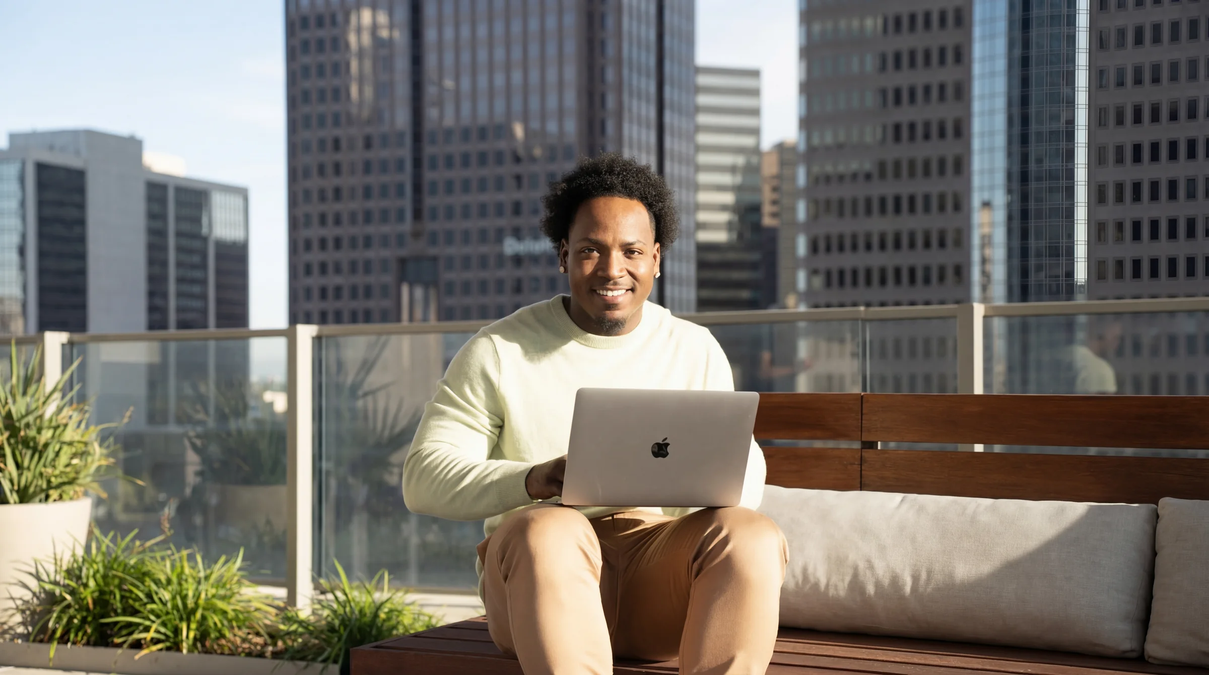 Jet working on a laptop on a city rooftop