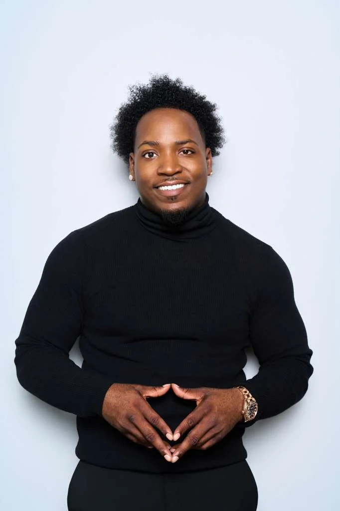 Jet in a black turtleneck, smiling