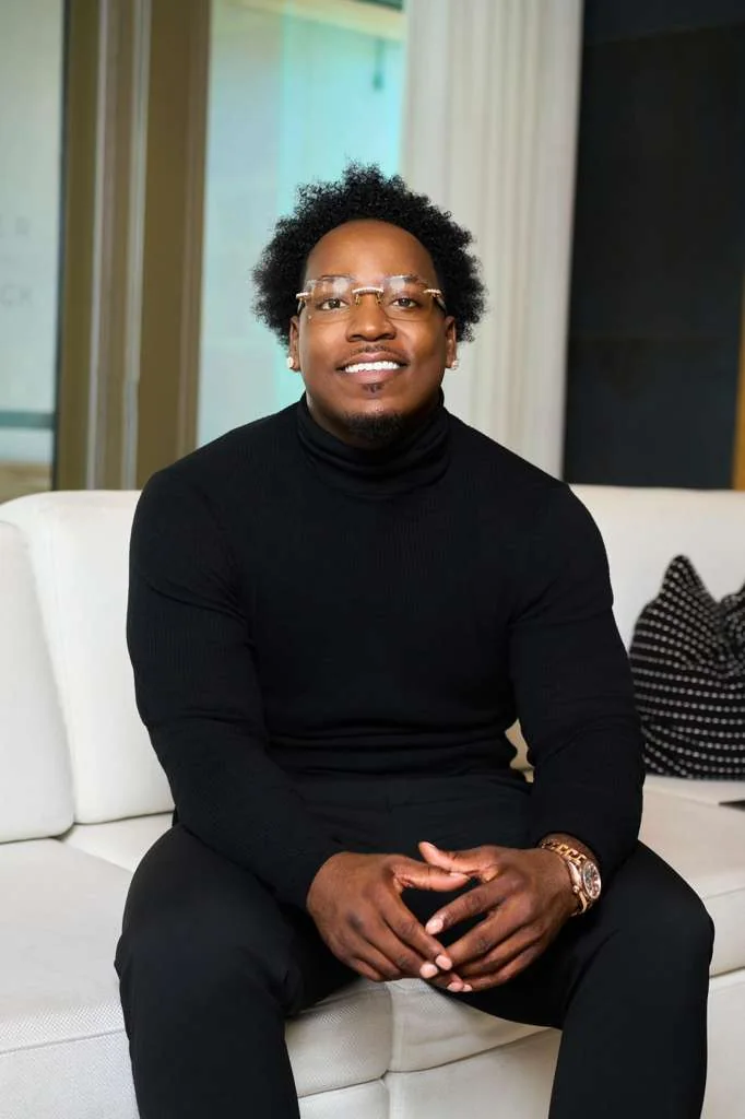 Jet seated on a white sofa, smiling